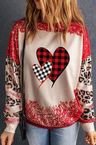 a woman wearing a red and black heart sweatshirt