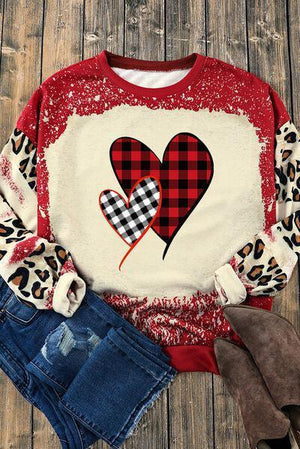 a red and black heart sweater with leopard print