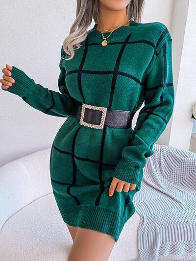 a woman in a green sweater dress posing for a picture