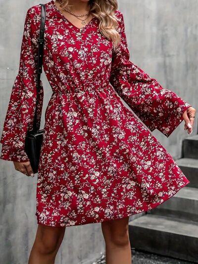 a woman wearing a red floral print dress
