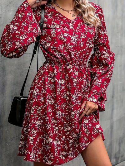 a woman wearing a red floral print dress
