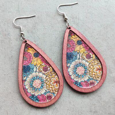a pair of pink leather earrings with floral designs
