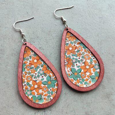 a pair of earrings with a floral design