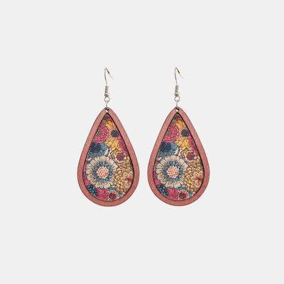 a pair of earrings with a floral design