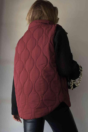 a woman wearing a red quilted vest
