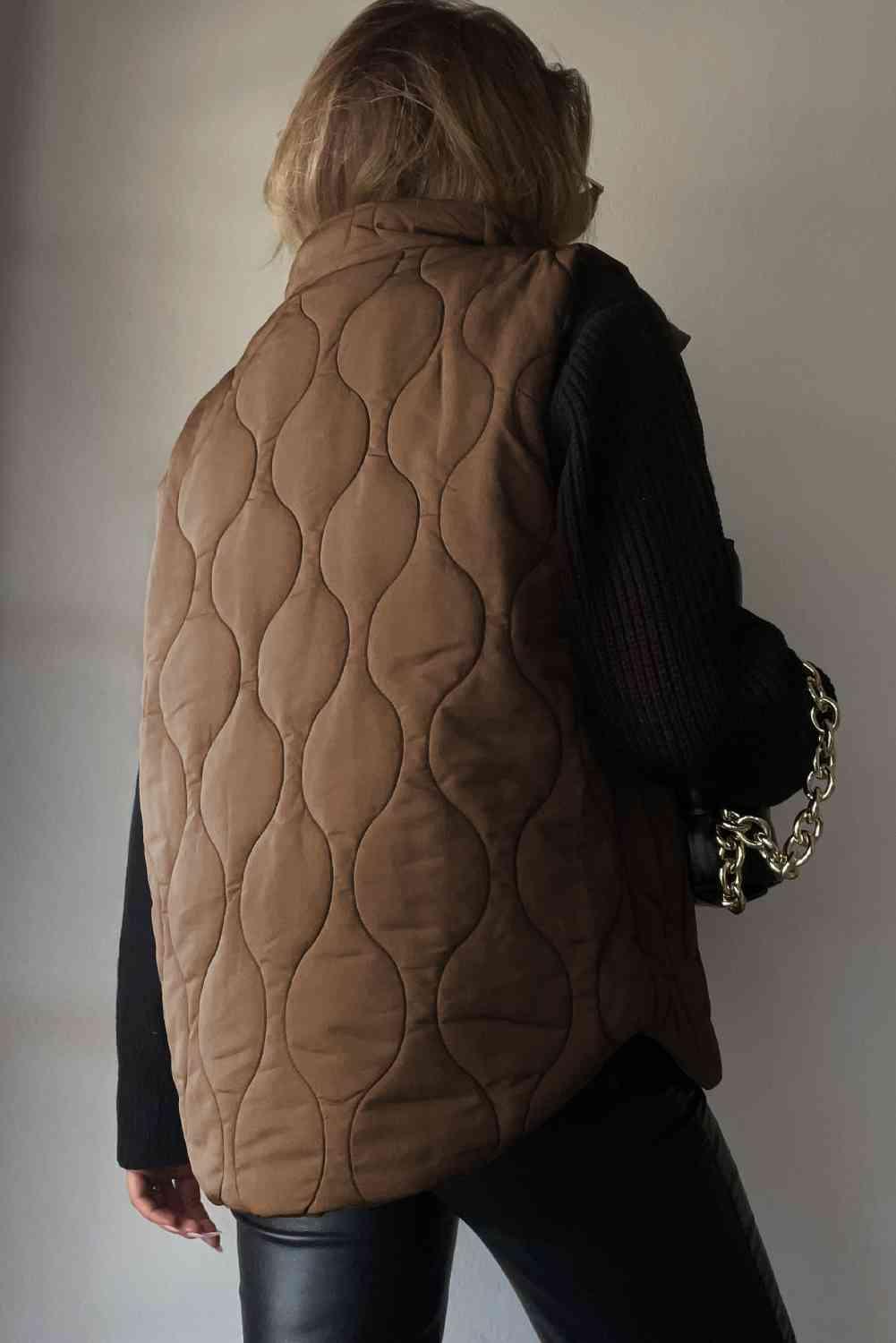 a woman wearing a brown quilted vest