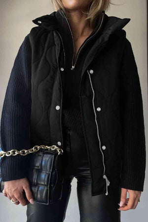 a woman wearing a black jacket and black pants