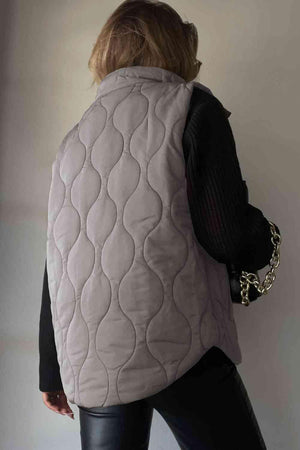 a woman wearing a white quilted vest