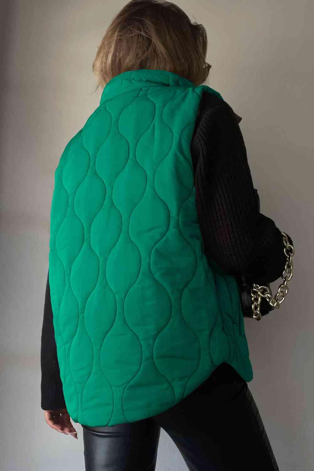 a woman wearing a green quilted vest