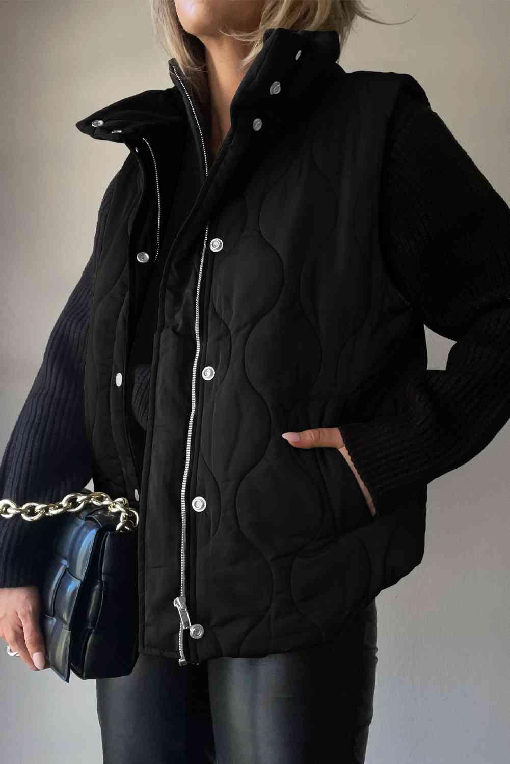 a woman wearing a black jacket and black pants