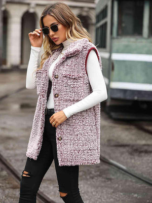 a woman wearing a pink tweed vest and black ripped jeans