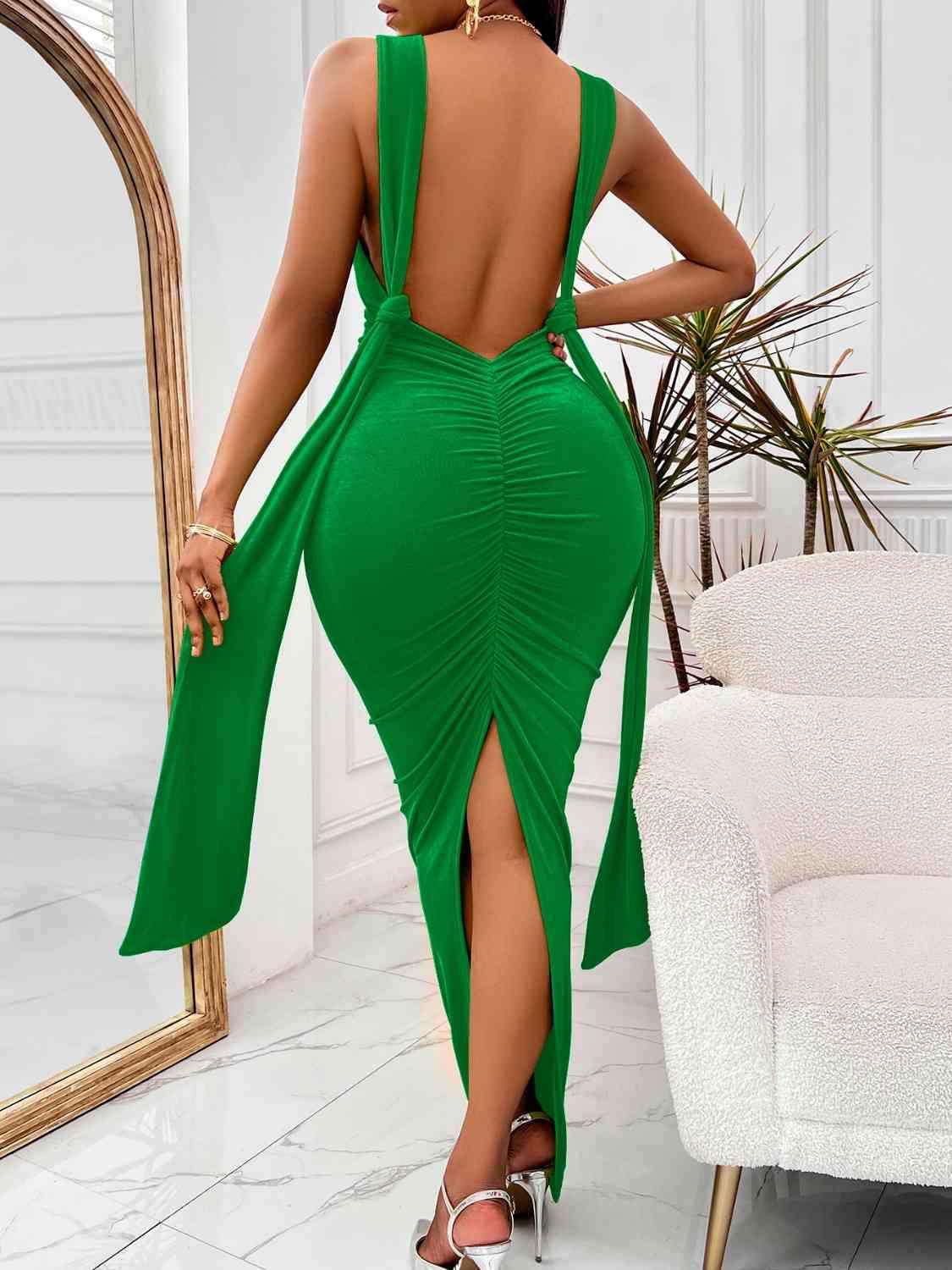 a woman in a green dress with a backless dress