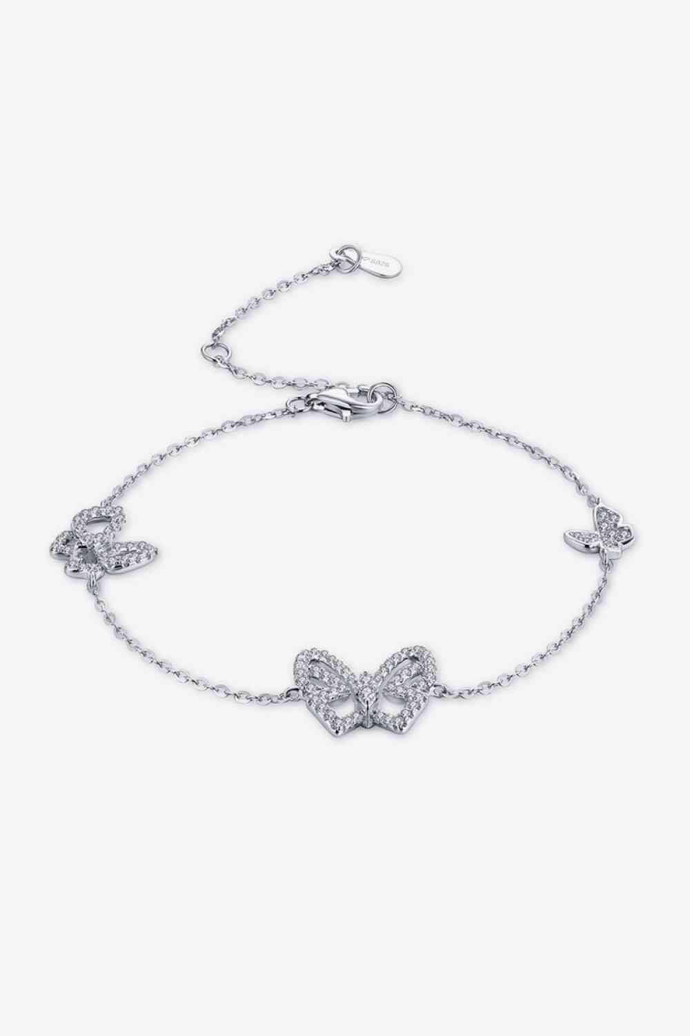 a silver bracelet with two butterflies on it