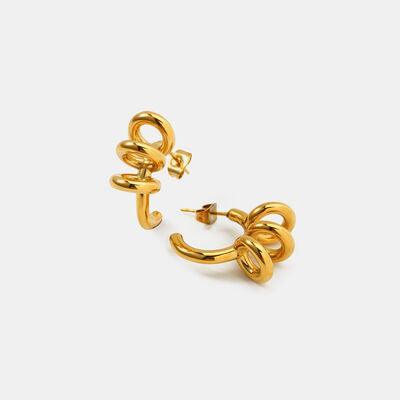 a pair of gold earrings on a white background