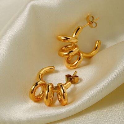 a close up of a pair of gold earrings