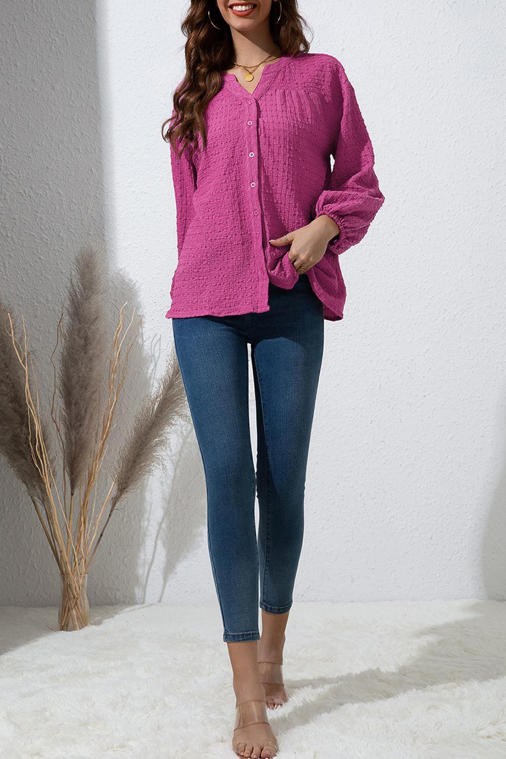 a woman in a pink shirt and jeans posing for a picture