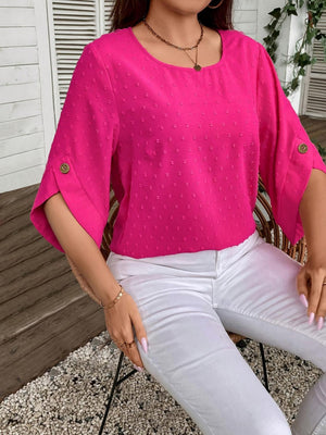 a woman sitting on a chair wearing a pink top