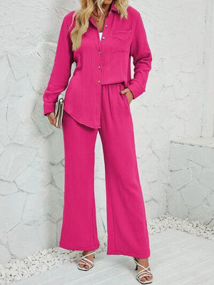 a woman in a bright pink outfit poses for a picture