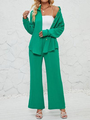 a woman in a green suit posing for a picture