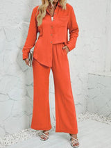 a woman in an orange jumpsuit posing for a picture