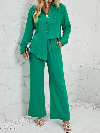 a woman in a green shirt and wide legged pants