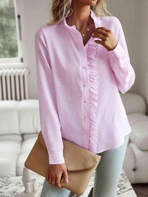 a woman wearing a pink shirt and jeans