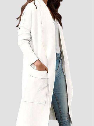 a woman wearing a white coat and jeans
