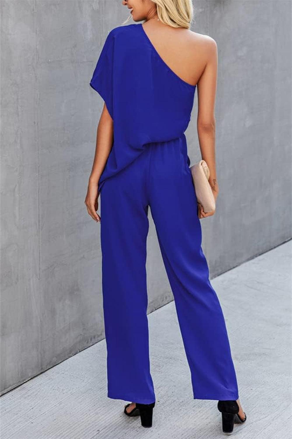 a woman in a blue one shoulder jumpsuit