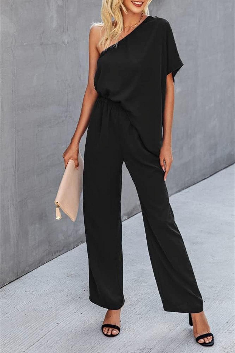 a woman wearing a black one shoulder jumpsuit