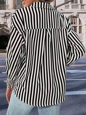 a woman wearing a black and white striped shirt