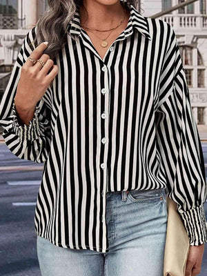 a woman wearing a black and white striped shirt