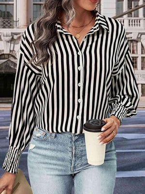 a woman wearing a black and white striped shirt