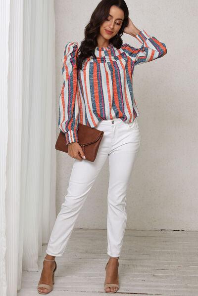 a woman in white pants and a striped shirt