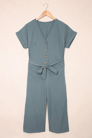 a woman's blue jumpsuit with a tie around the waist