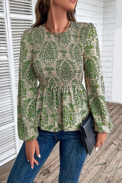 a woman wearing a green blouse and jeans