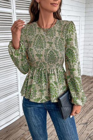 a woman wearing a green blouse and jeans