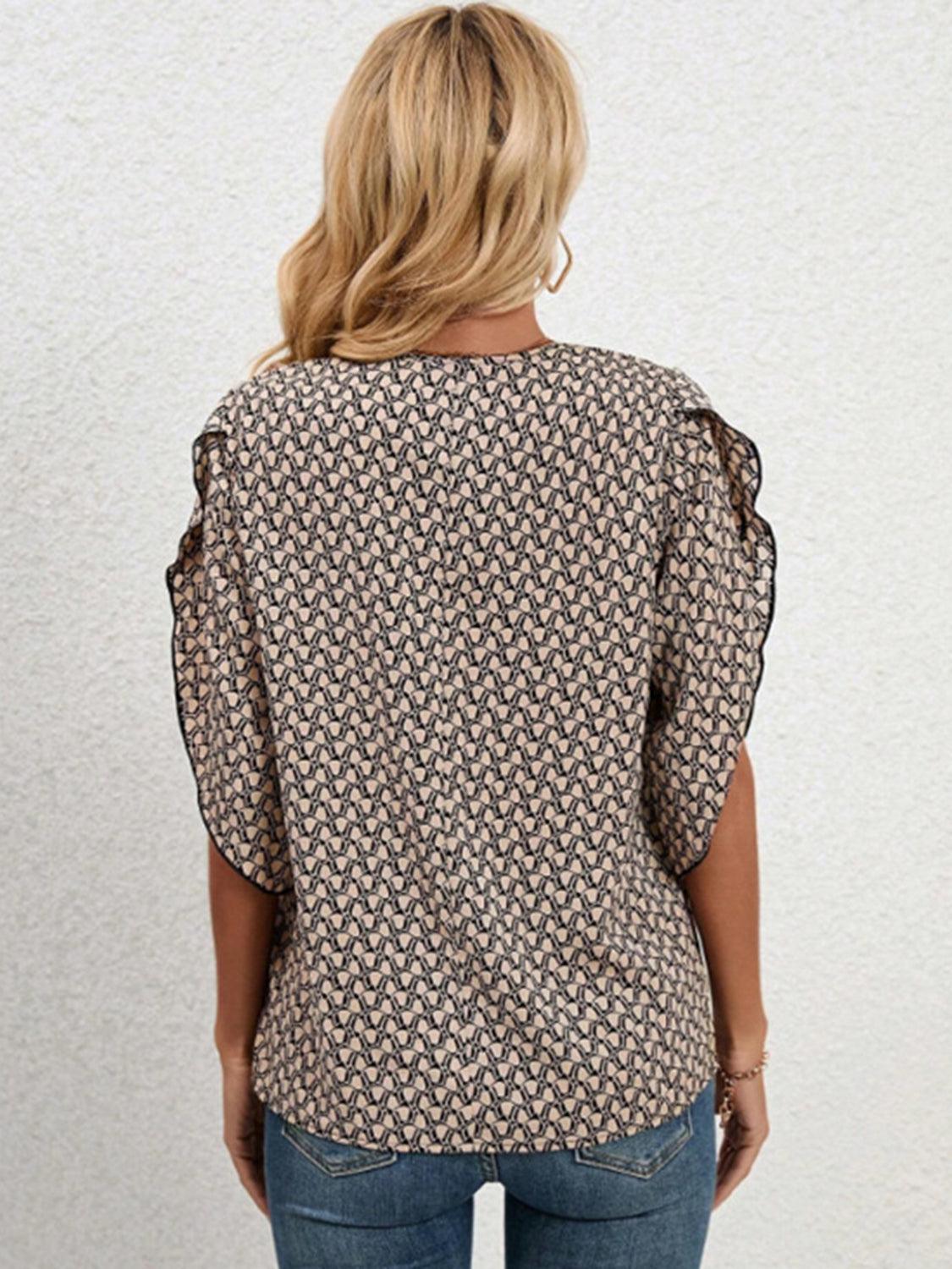a woman wearing a top with a pattern on it