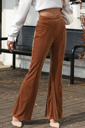 a woman standing on a porch holding a cup of coffee