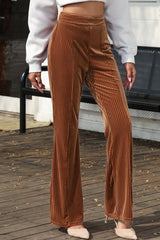 a woman in a white shirt and brown pants