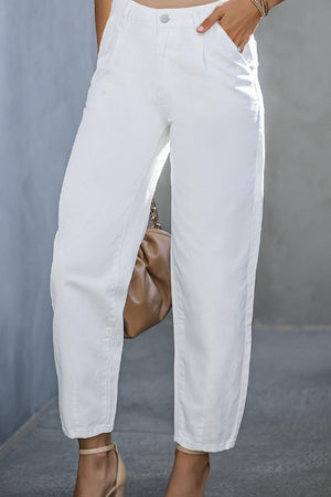 a woman is wearing white pants and heels