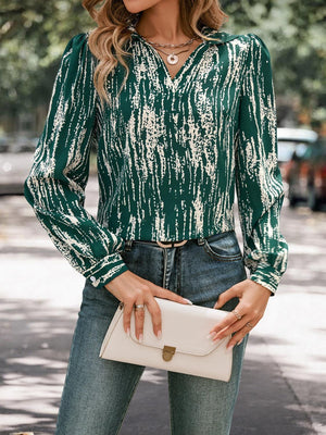 a woman wearing a green blouse and jeans