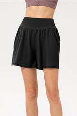 a woman in black shorts standing on a white background