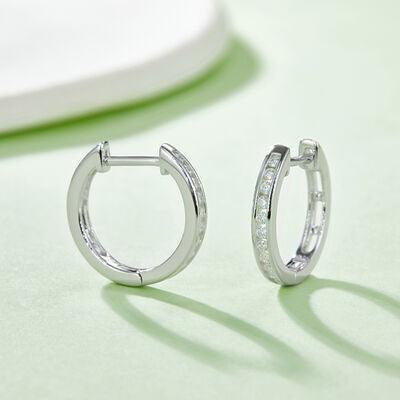 a pair of diamond hoop earrings on a table