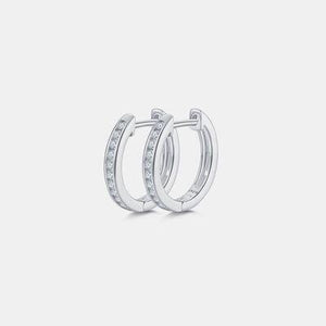 a pair of diamond hoop earrings on a white background