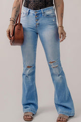 a woman in a black top and jeans holding a purse