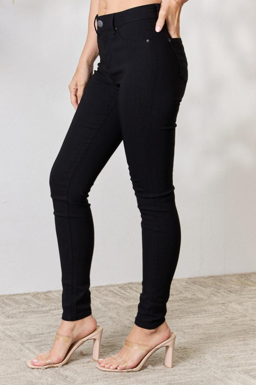 a woman wearing high heels and a black pants