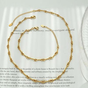 a gold chain bracelet with a heart charm