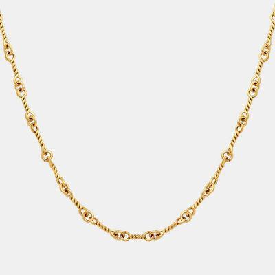a gold necklace with a chain on a white background