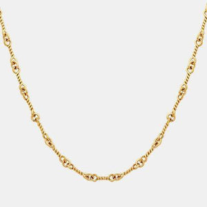 a gold necklace with a chain on a white background