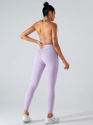 a woman in a purple sports bra top and leggings